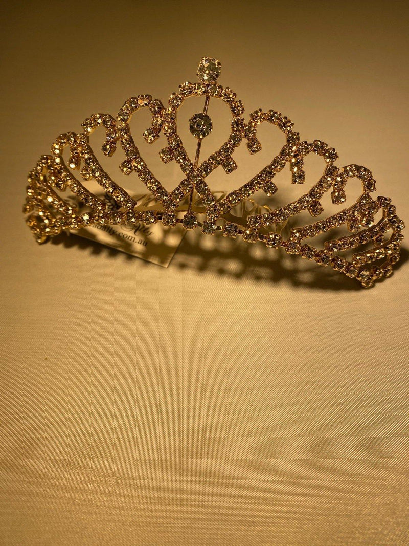 This gold tiara with overlapping heart design and sparkling crystals makes it a stunning accessory to any attire, with slide comb attached.