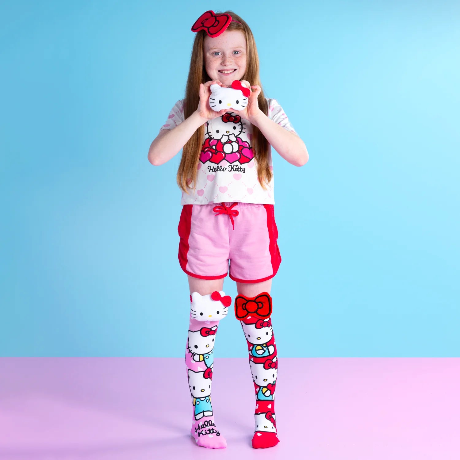 Hello Kitty knee high socks by MADMIA with 3D plush character head and red bow design