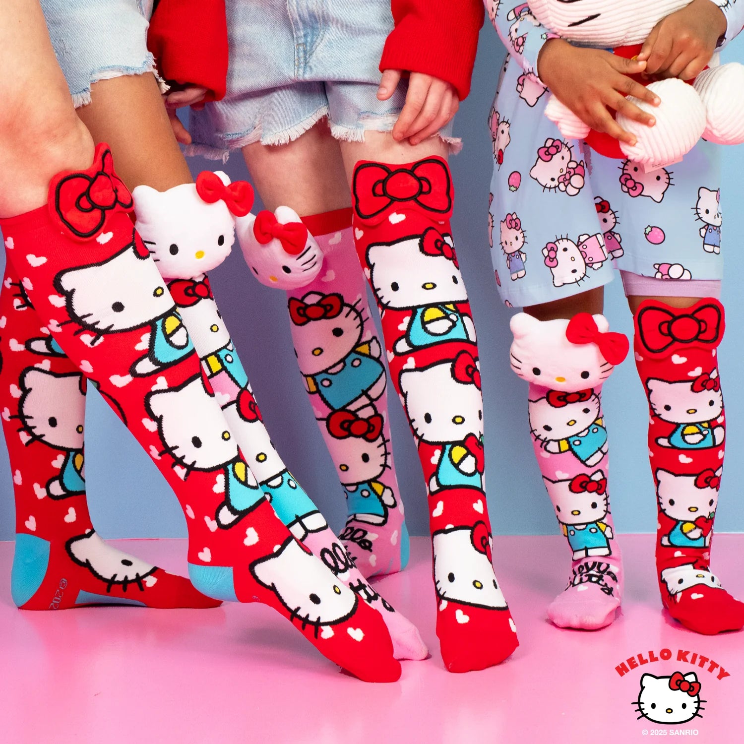 Hello Kitty knee high socks by MADMIA with 3D plush character head and red bow design