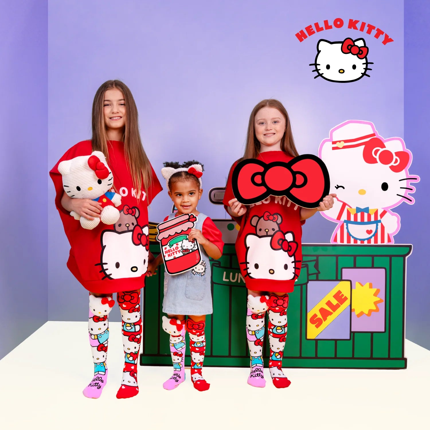 Hello Kitty knee high socks by MADMIA with 3D plush character head and red bow design